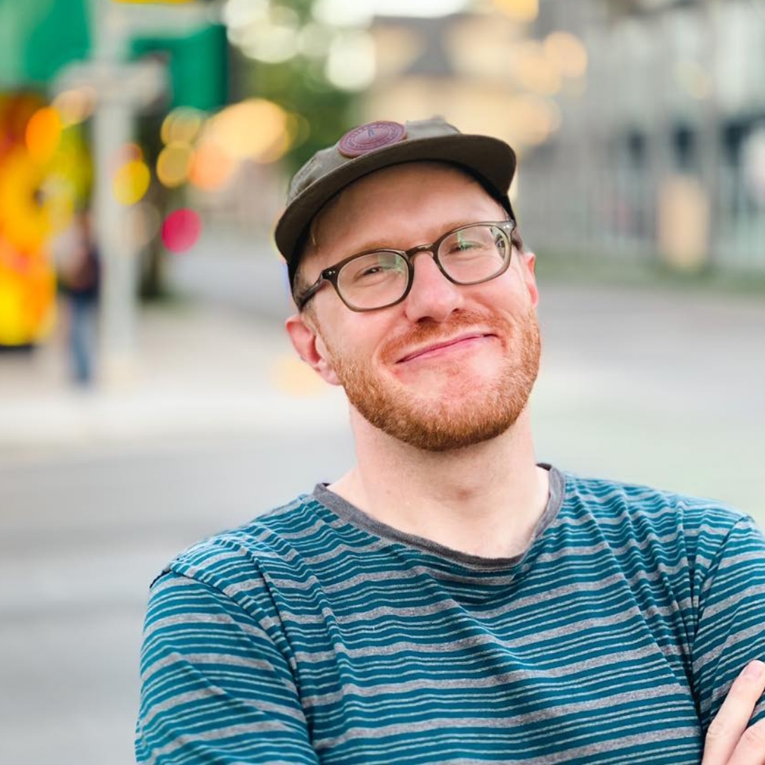 Director of 541 Eatery & Exchange, a smiling young man with a blue striped t-shirt.