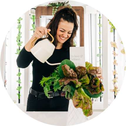 Staff Member at Mon Petit Chou, watering a flower arrangement