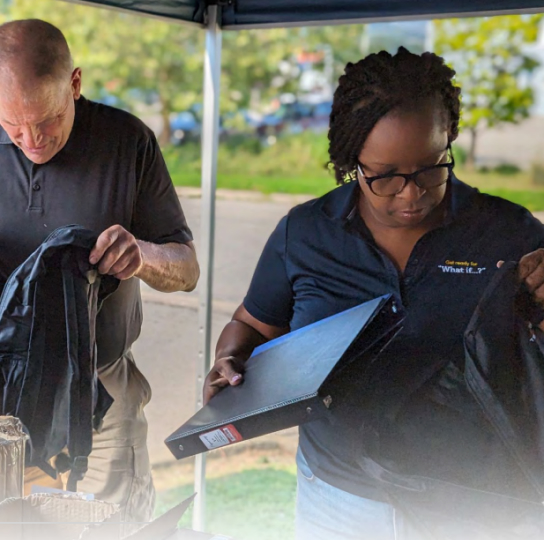 Meridian employees packing essential items for community kits 