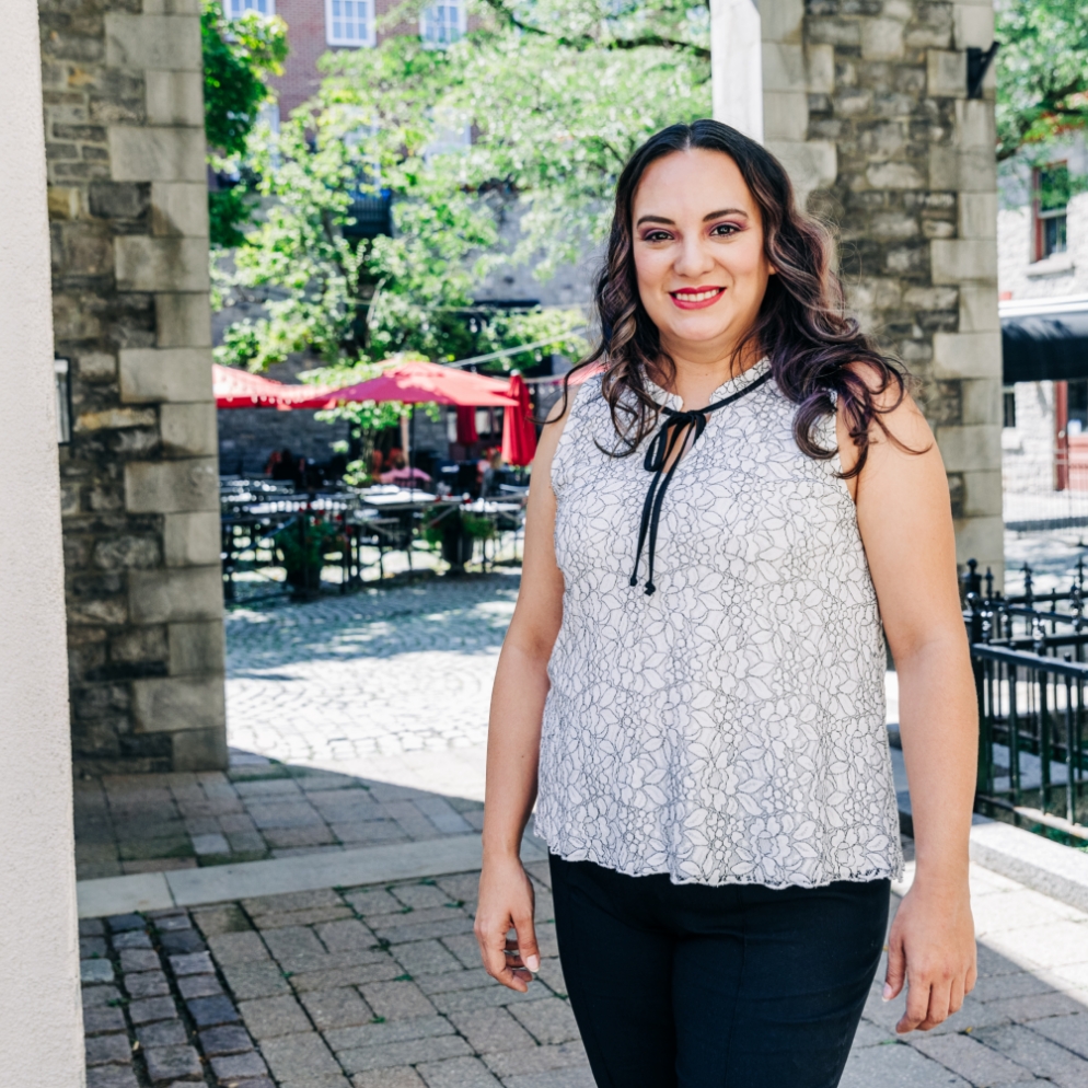 Meridian Business Member Crafts by Adjope, a woman smiling and standing confidently outside.