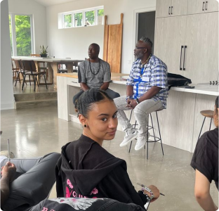 A dark-skinned young woman in a class-room setting at Breaking Bread Retreats